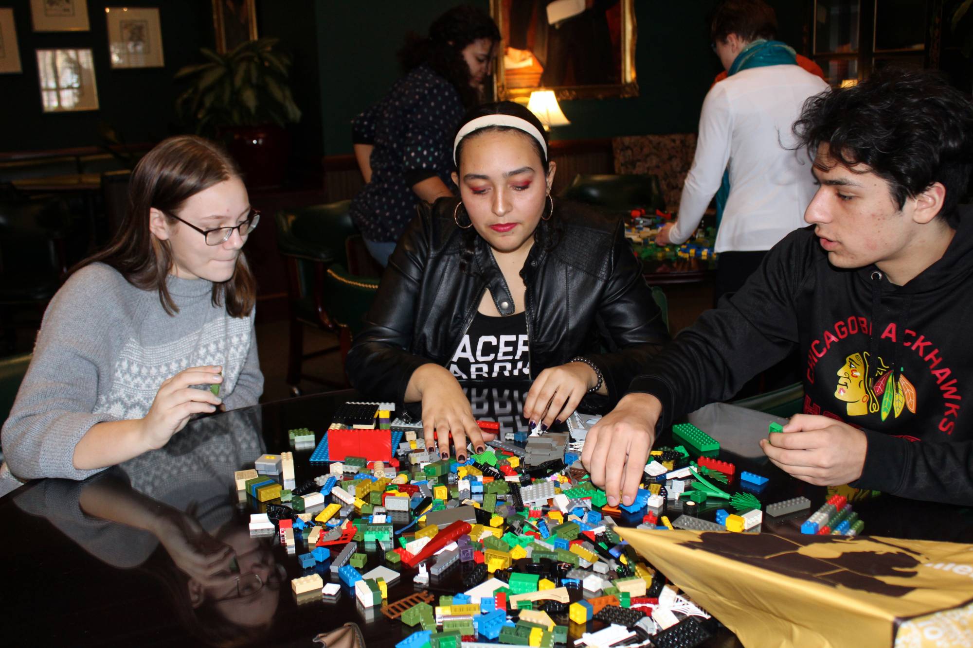 Scholars working on LEGO at a meeting